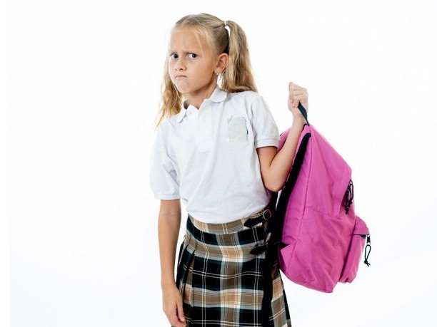 child-holding-backpack
